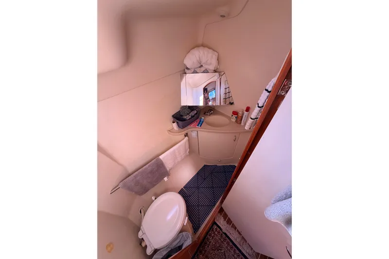 Slide: The Image of Compact bathroom in 2005 Hunter Passage 456 yacht with sink, mirror, and toilet. - 68