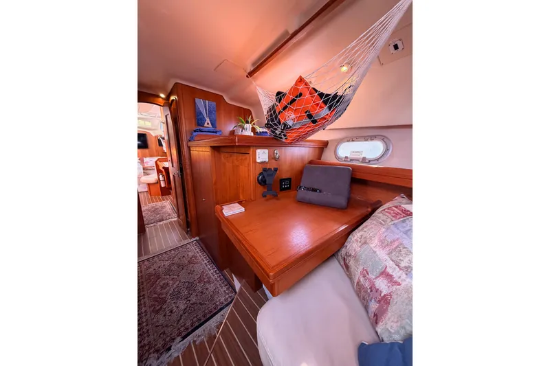 Slide: The Image of Interior of 2005 Hunter Passage 456 sailboat with wooden furnishings and cozy seating area. - 73