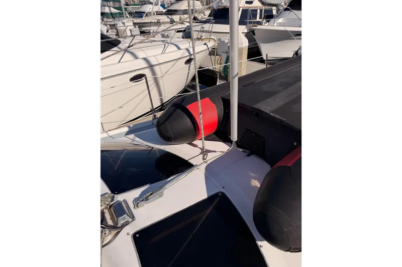 Slide: The Image of 2005 Hunter Passage 456 sailboat docked with visible deck and fenders. - 16