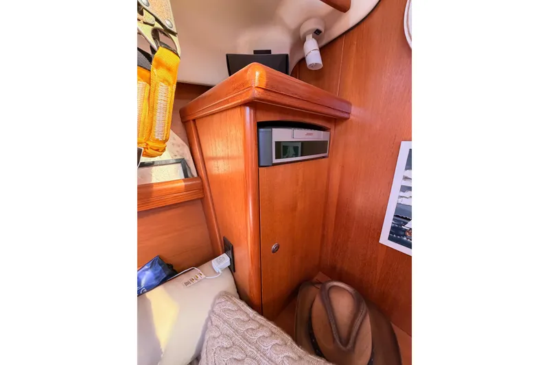 Slide: The Image of Interior of 2005 Hunter Passage 456 yacht with wooden cabinetry and Bose audio system. - 52