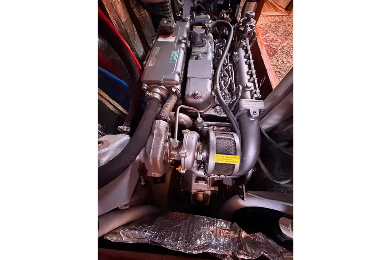 Slide: The Image of Engine of 2005 Hunter Passage 456 sailboat, detailed view with hoses and components. - 87
