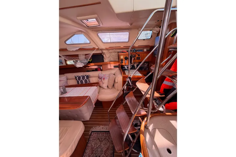 Slide: The Image of Interior of 2005 Hunter Passage 456 yacht with cozy seating and wooden accents. - 43