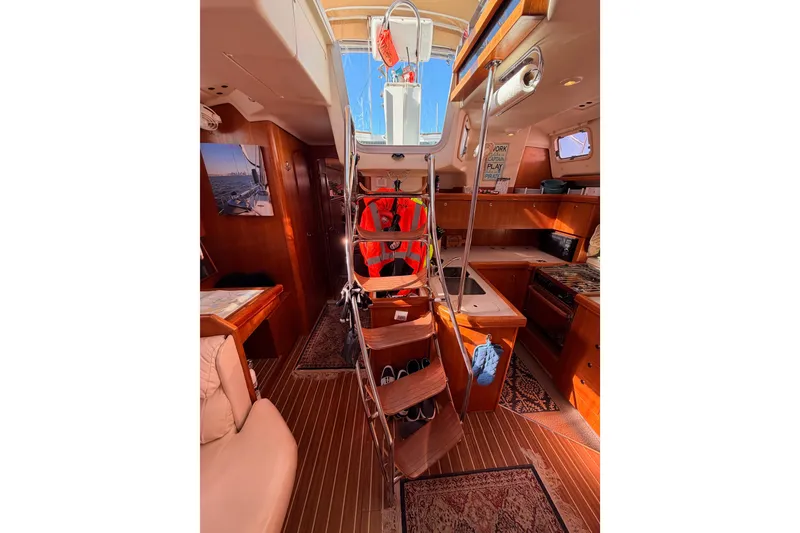 Slide: The Image of Interior of 2005 Hunter Passage 456 yacht with wooden finish and ladder to deck. - 82