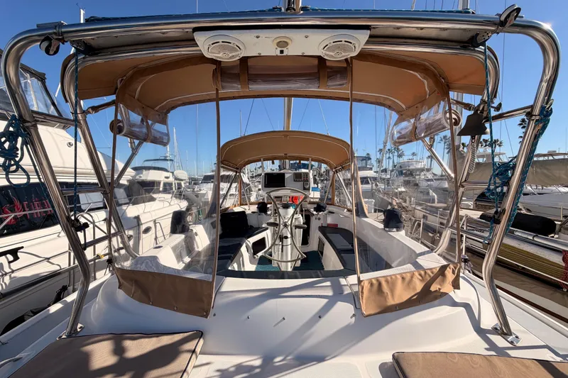 Slide: The Image of 2005 Hunter Passage 456 sailboat cockpit with canopy, docked in a marina. - 26