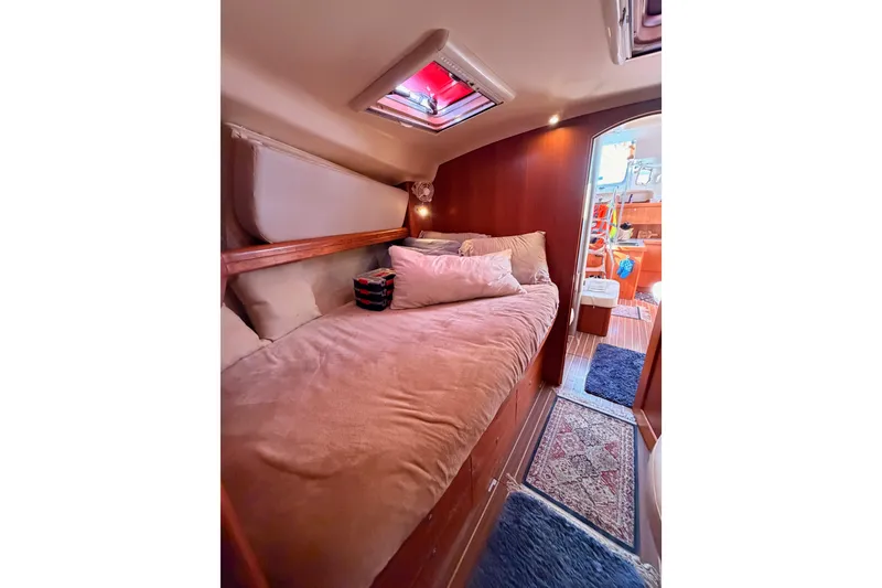 Slide: The Image of Cozy cabin interior of 2005 Hunter Passage 456 yacht with plush bedding and warm lighting. - 61
