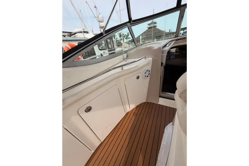 Slide: The Image of 2005 Sea Ray 300 Sundancer interior with wood flooring and sleek design. - 14