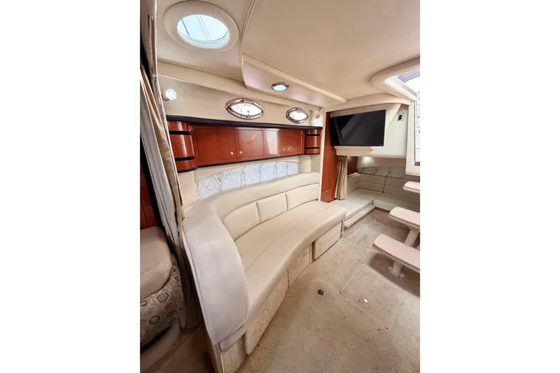 Slide: The Image of Interior of 2005 Sea Ray 300 Sundancer yacht with beige seating and wood cabinetry. - 37