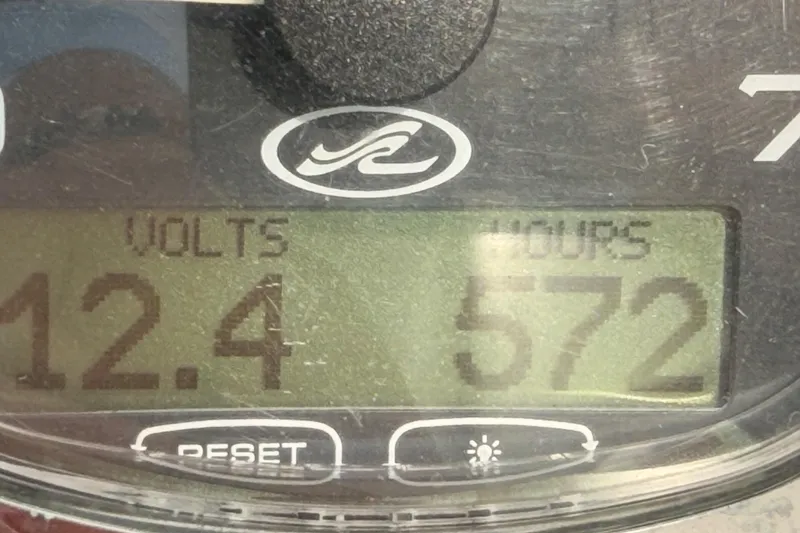 Slide: The Image of Close-up of a Sea Ray 300 Sundancer gauge showing 12.4 volts and 572 hours. - 46