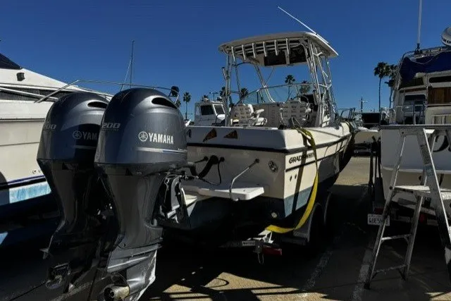 Slide: The Image of 2004 Grady-White Gulfstream 232 boat with twin Yamaha engines in a marina setting. - 17