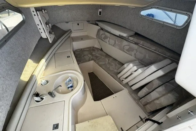 Slide: The Image of 2004 Grady-White Gulfstream 232 cabin interior with seating and compact sink area. - 12