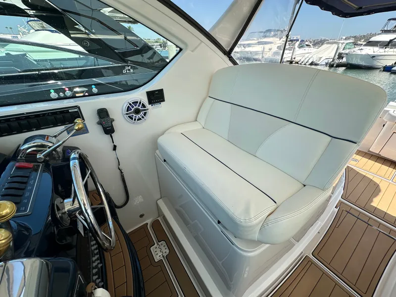 Slide: The Image of The image shows the helm of a 2007 Tiara Yachts 3000 Open with a white seat and wood flooring. - 13
