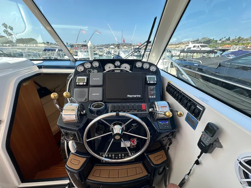 Slide: The Image of The cockpit of a 2007 Tiara Yachts 3000 Open with modern navigation instruments and a sleek steering wheel. - 19
