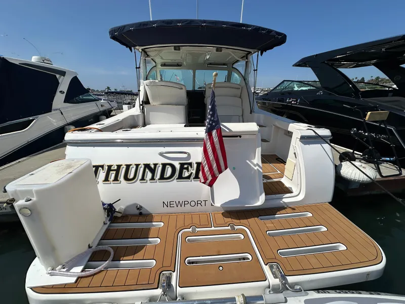Slide: The Image of A 2007 Tiara Yachts 3000 Open with a spacious cockpit and an American flag. - 14