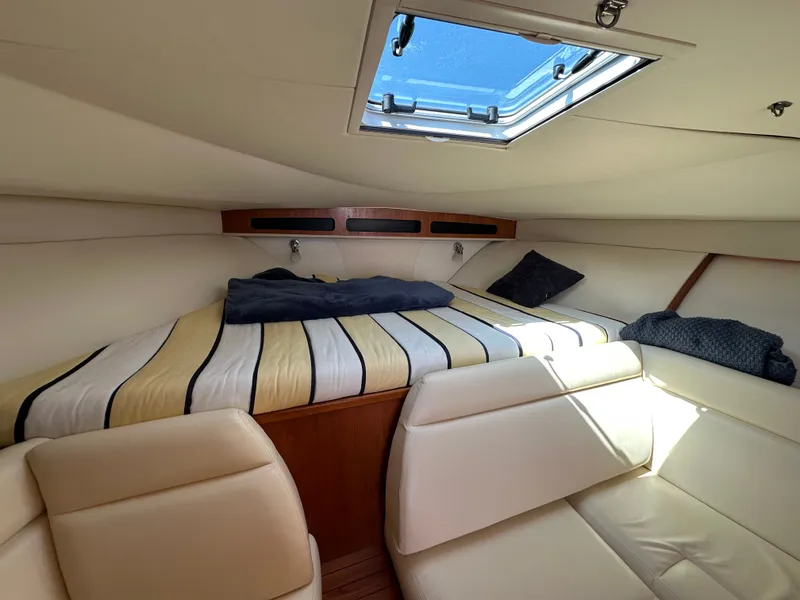 Slide: The Image of The cabin of a 2007 Tiara Yachts 3000 Open with a bed and a skylight. - 33