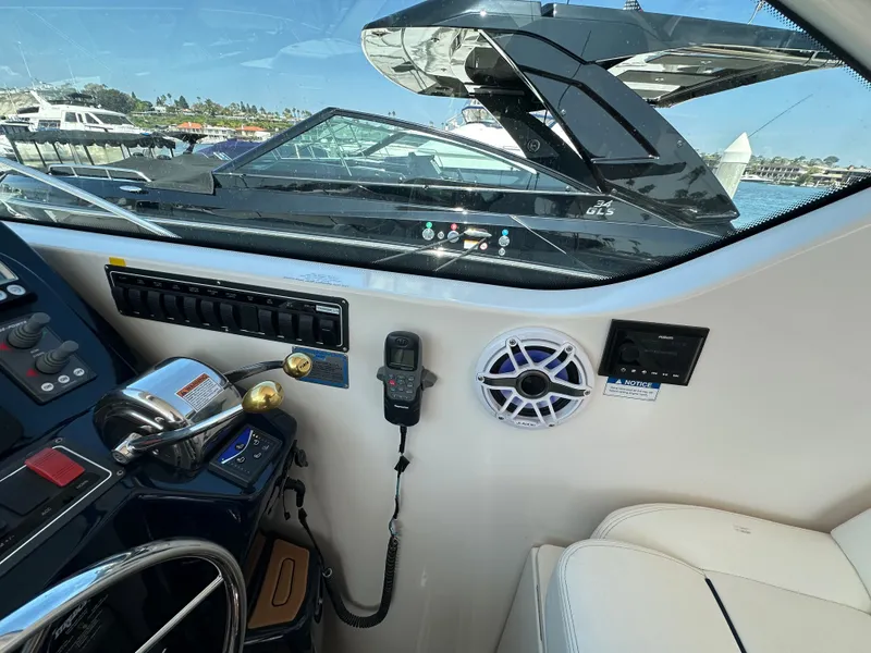 Slide: The Image of The cockpit of a 2007 Tiara Yachts 3000 Open with controls and communication devices. - 54