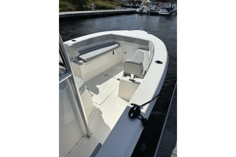 Slide: The Image of 2024 KenCraft 215 Center Console boat docked, featuring spacious seating and sleek design. - 21