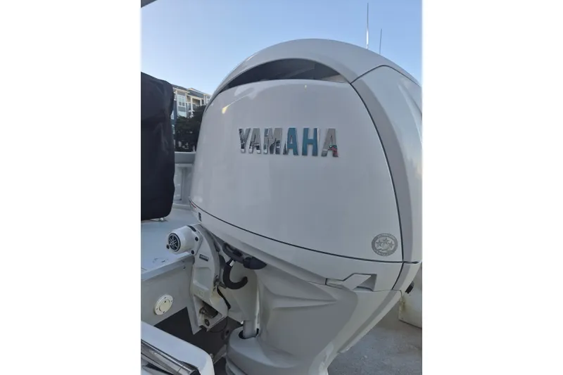 Slide: The Image of Yamaha outboard motor on 2024 KenCraft 215 Center Console boat, docked outdoors. - 19