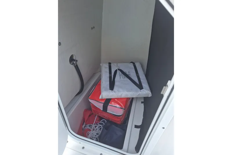 Slide: The Image of Storage compartment in 2024 KenCraft 215 Center Console boat with safety gear and equipment. - 15