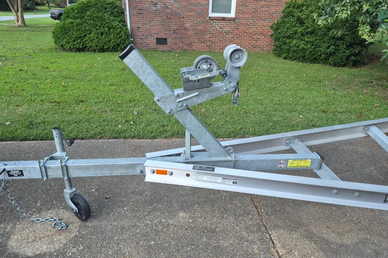 Slide: The Image of Trailer for 2024 KenCraft 215 Center Console boat on driveway, ready for transport. - 28