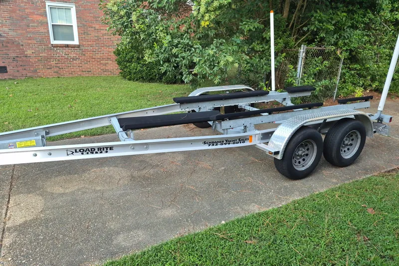 Slide: The Image of Trailer for 2024 KenCraft 215 Center Console boat, parked on driveway. - 27