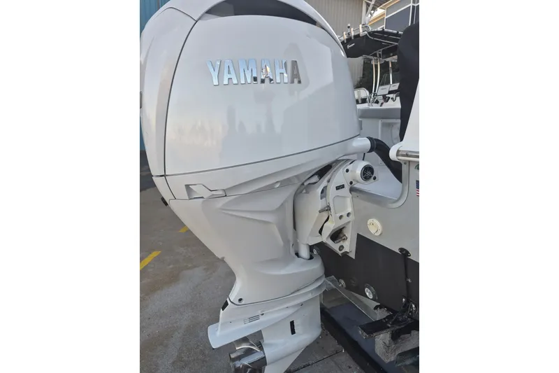Slide: The Image of Yamaha outboard motor on 2024 KenCraft 215 Center Console boat, docked outdoors. - 20