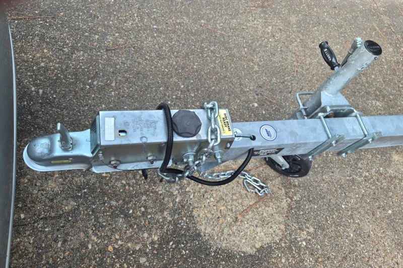 Slide: The Image of Trailer hitch of a 2024 KenCraft 215 Center Console boat on pavement. - 29