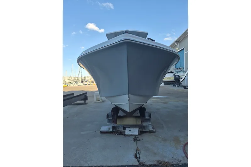 Slide: The Image of 2024 KenCraft 215 Center Console boat on a dock, viewed from the front. - 17