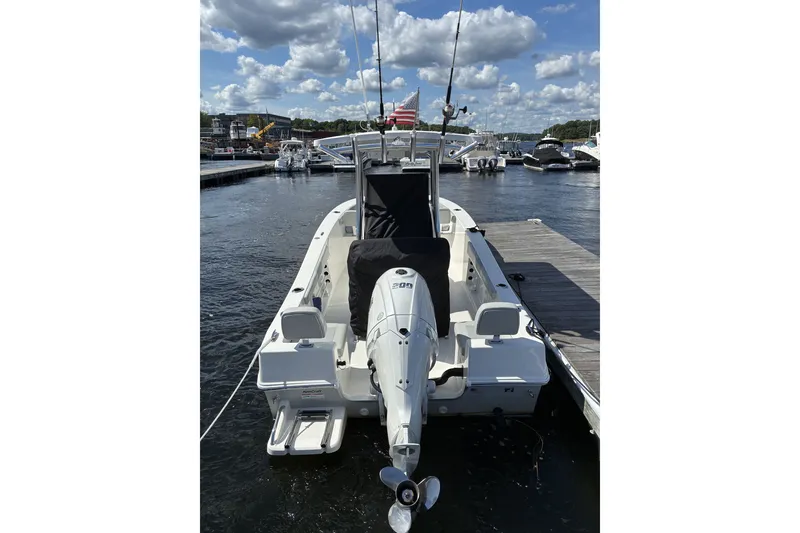 Slide: The Image of 2024 KenCraft 215 Center Console boat docked at marina under blue sky. - 22