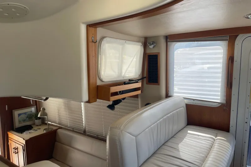 Slide: The Image of Interior of 2003 American Tug 34 with white seating and wooden accents. - 35