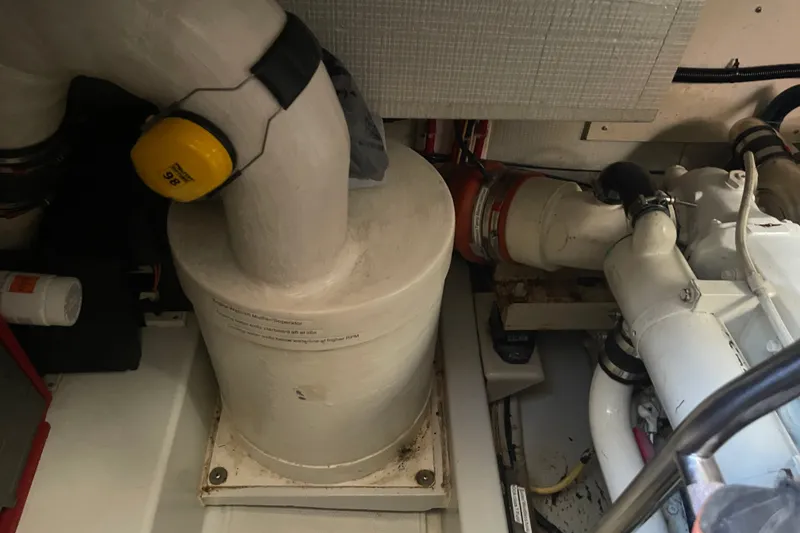 Slide: The Image of Engine room of a 2003 American Tug 34, featuring exhaust and filtration components. - 26
