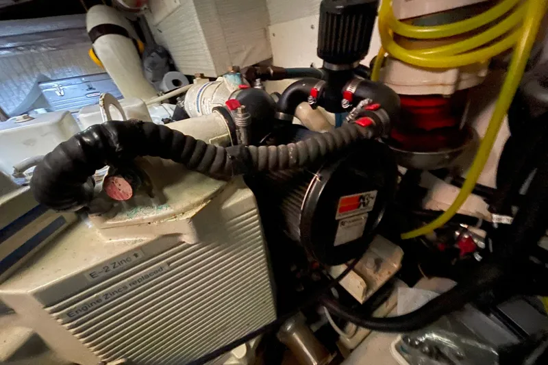 Slide: The Image of Engine room of a 2003 American Tug 34, showcasing mechanical components and hoses. - 39
