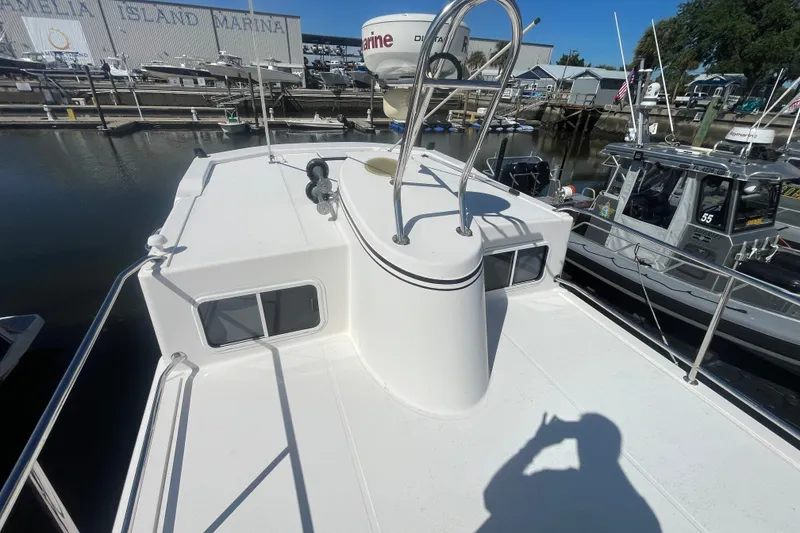 Slide: The Image of 2003 American Tug 34 on deck at marina, showcasing radar and railing. - 6