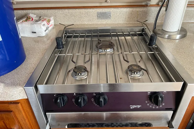 Slide: The Image of Stainless steel stove with three burners on a 2003 American Tug 34 boat. - 11
