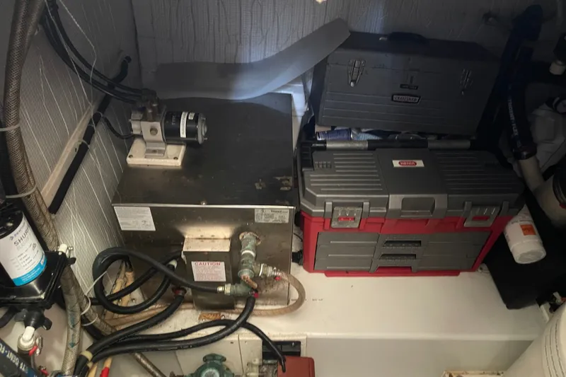 Slide: The Image of Engine room of a 2003 American Tug 34 with toolboxes and equipment. - 23