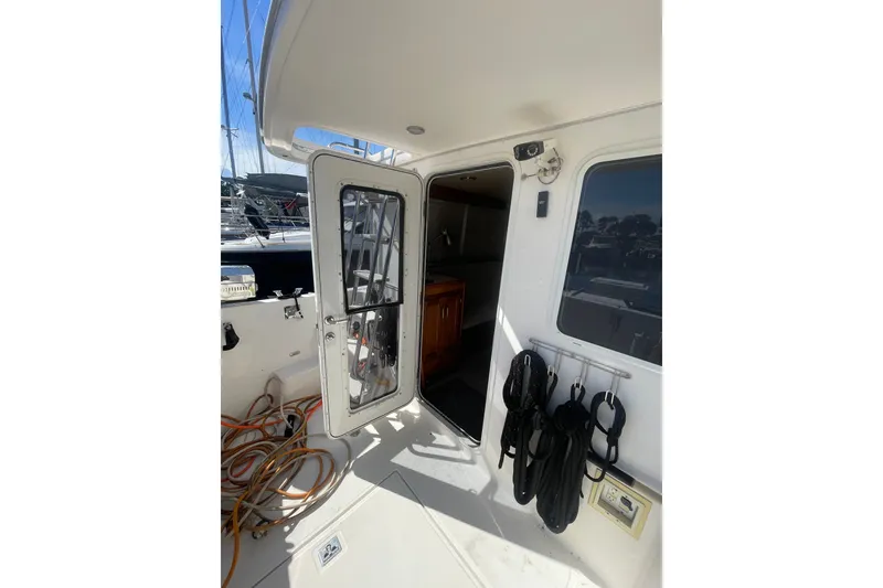 Slide: The Image of 2003 American Tug 34 boat entrance with open door and docked ropes. - 3