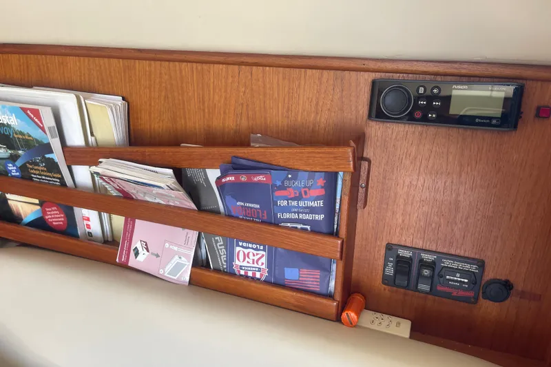Slide: The Image of Interior of 2003 American Tug 34 with wooden magazine rack and control panel. - 17