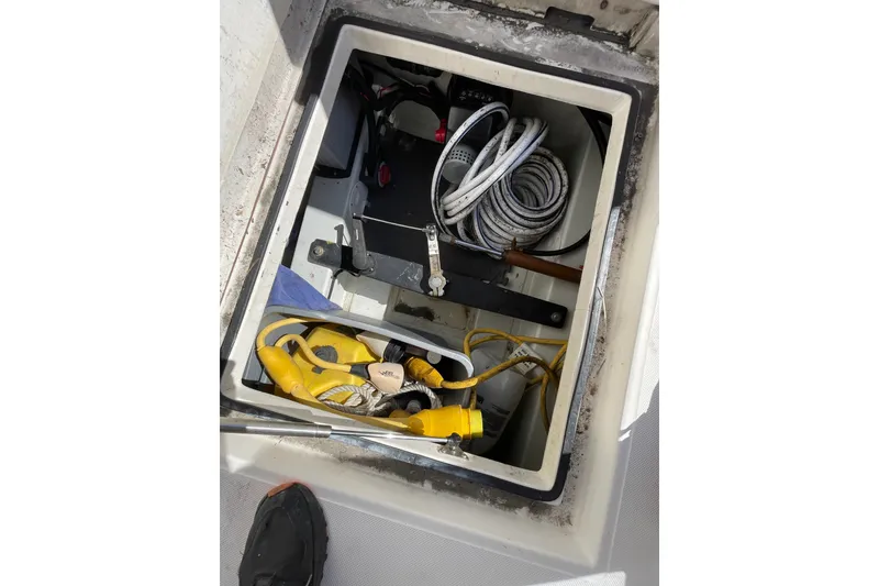 Slide: The Image of Storage compartment of a 2003 American Tug 34, containing ropes and equipment. - 20