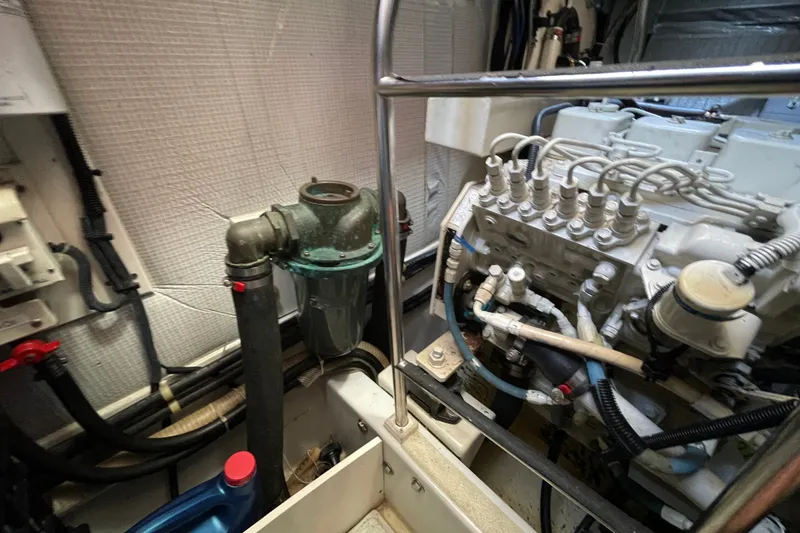 Slide: The Image of Engine room of a 2003 American Tug 34, showcasing mechanical components and piping. - 30