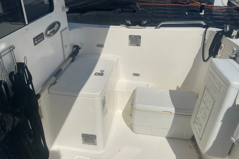 Slide: The Image of 2003 American Tug 34 boat deck with storage compartments and equipment. - 9