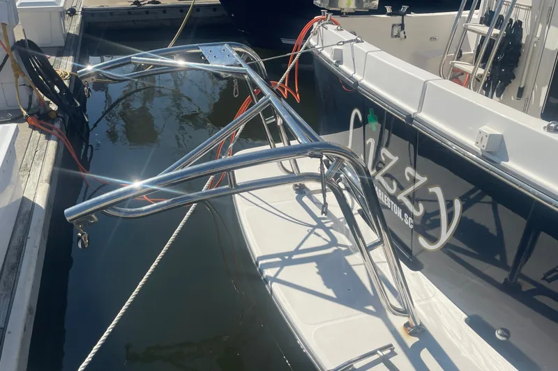 Slide: The Image of American Tug 34 boat docked, featuring shiny metal railings and "Lizzy" name on the side. - 8