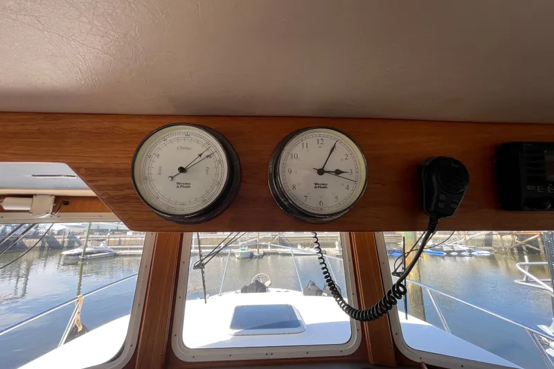 Slide: The Image of Interior view of a 2003 American Tug 34, featuring gauges and a microphone. - 37