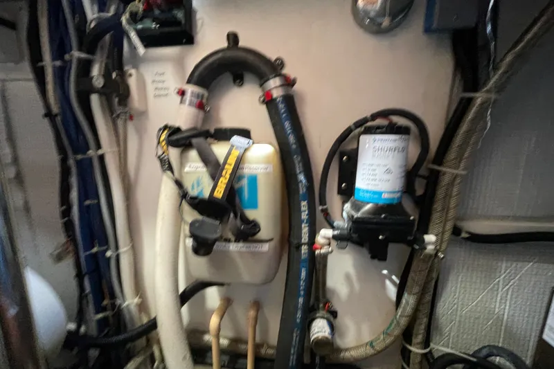 Slide: The Image of Engine room of a 2003 American Tug 34, featuring various pipes and equipment. - 22