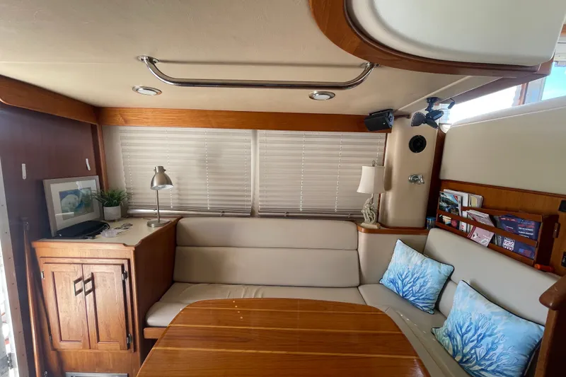 Slide: The Image of Interior of 2003 American Tug 34 with cozy seating and nautical decor. - 14