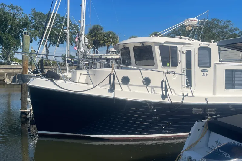 Slide: The Image of 2003 American Tug 34 docked, featuring a classic design and sturdy build. - 1