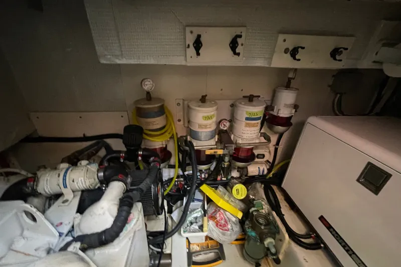 Slide: The Image of Engine room of a 2003 American Tug 34 with fuel filters and mechanical components. - 25