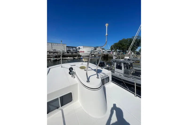 Slide: The Image of 2003 American Tug 34 boat deck with radar and antenna, docked at marina. - 7