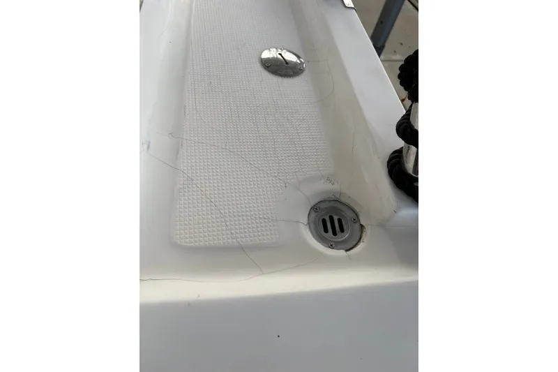 Slide: The Image of Cracked deck surface of 2003 Symbol 50 Pilothouse boat with drain and textured grip. - 65