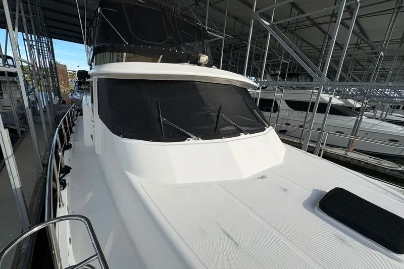 Slide: The Image of 2003 Symbol 50 Pilothouse yacht docked in a covered marina. - 69