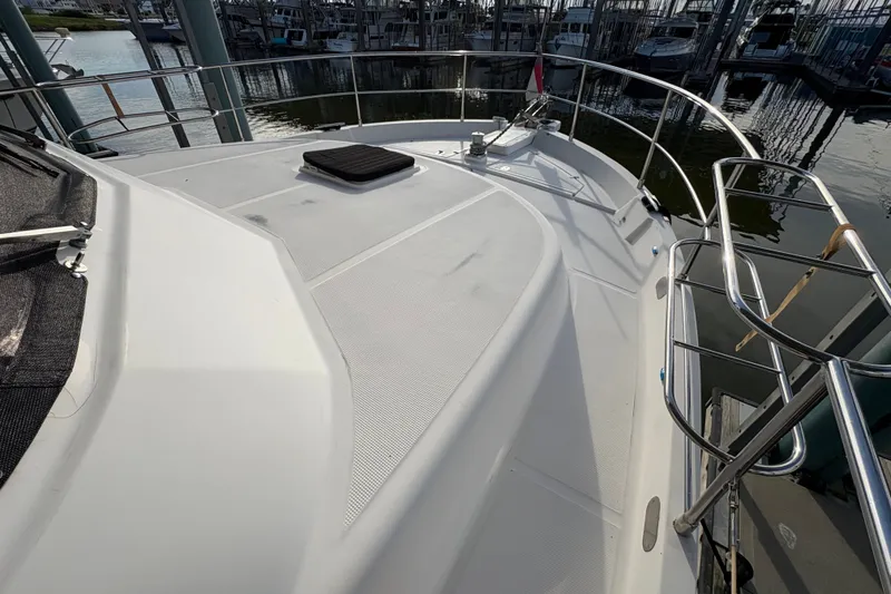 Slide: The Image of Deck view of a 2003 Symbol 50 Pilothouse yacht in a marina setting. - 66
