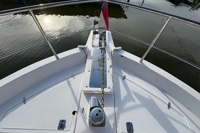 Slide: The Image of Bow view of 2003 Symbol 50 Pilothouse yacht with anchor chain and calm water reflection. - 67